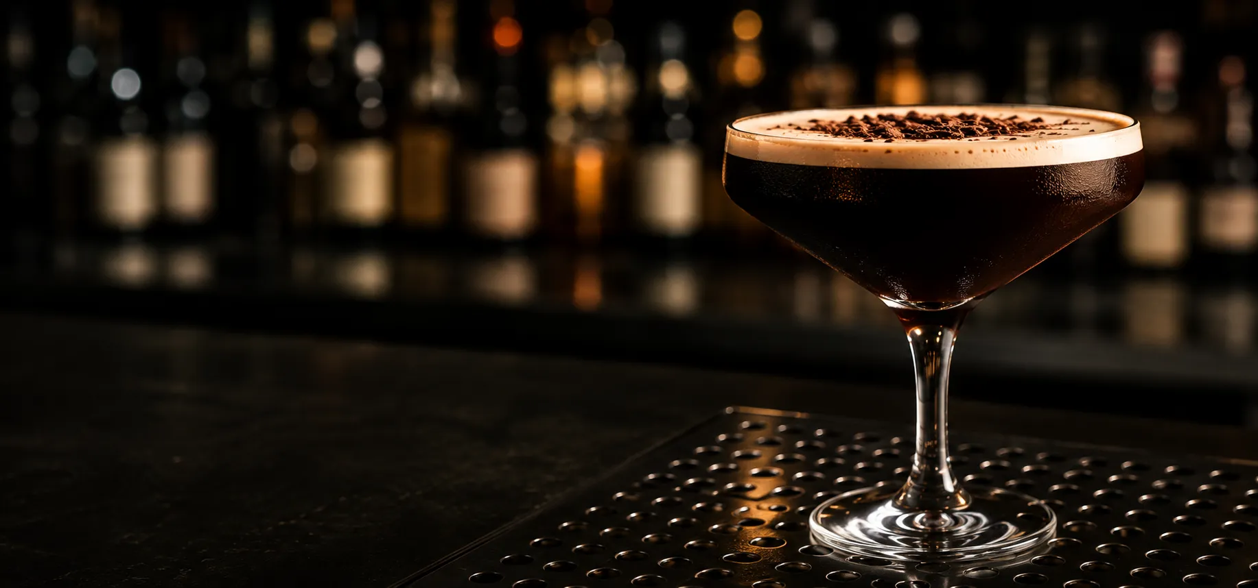 A cocktail in a coupe glass on a bar